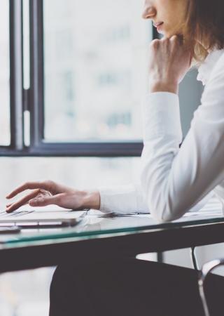 a woman in working on her laptop